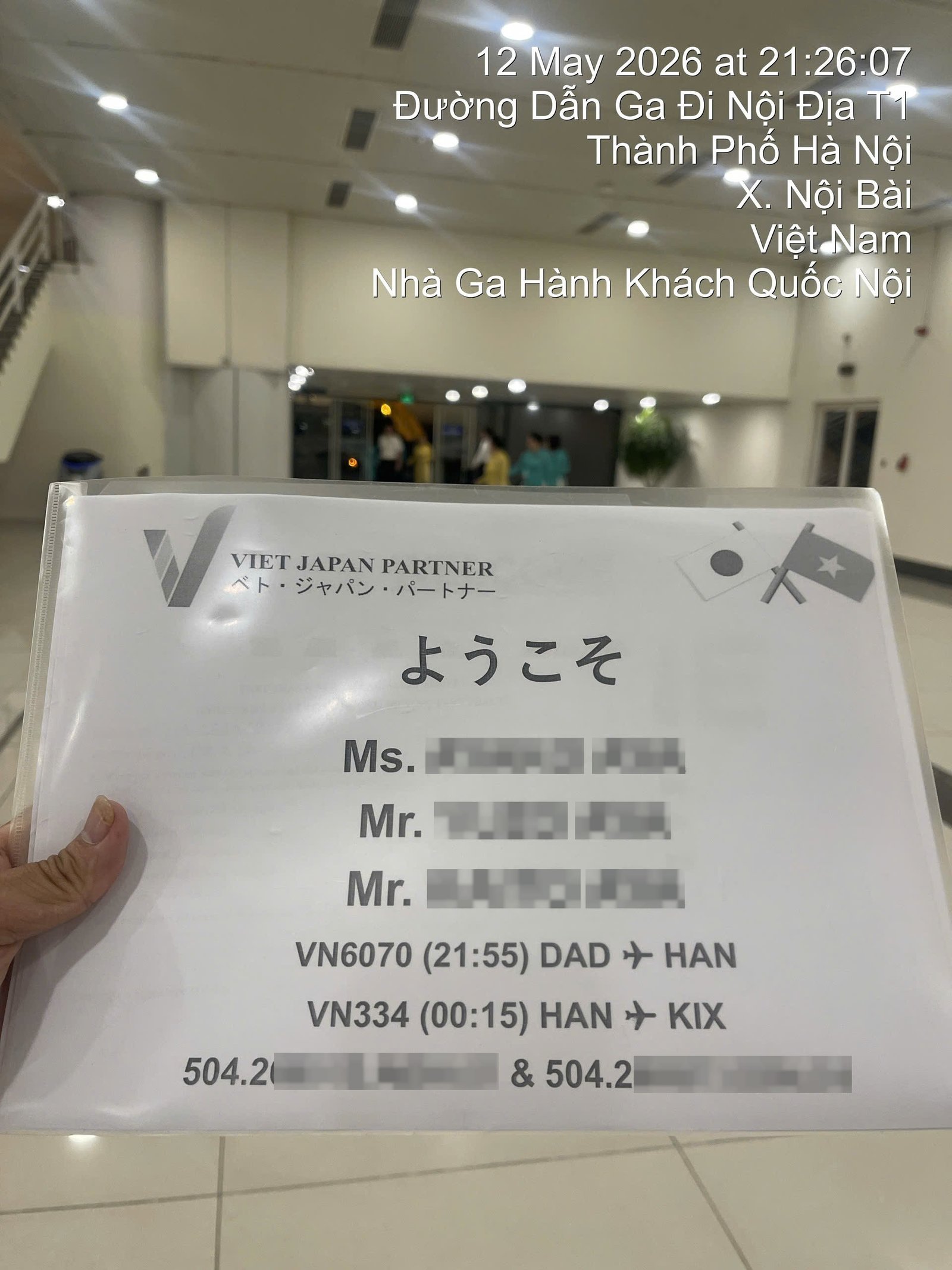 Welcome board prepared for a Japanese family at the domestic terminal of Noi Bai International Airport